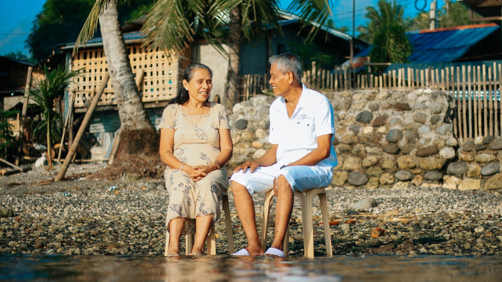 Senior couple relaxing side by side on a sunny beach, the kind of trip many plan on cruises for seniors over 60